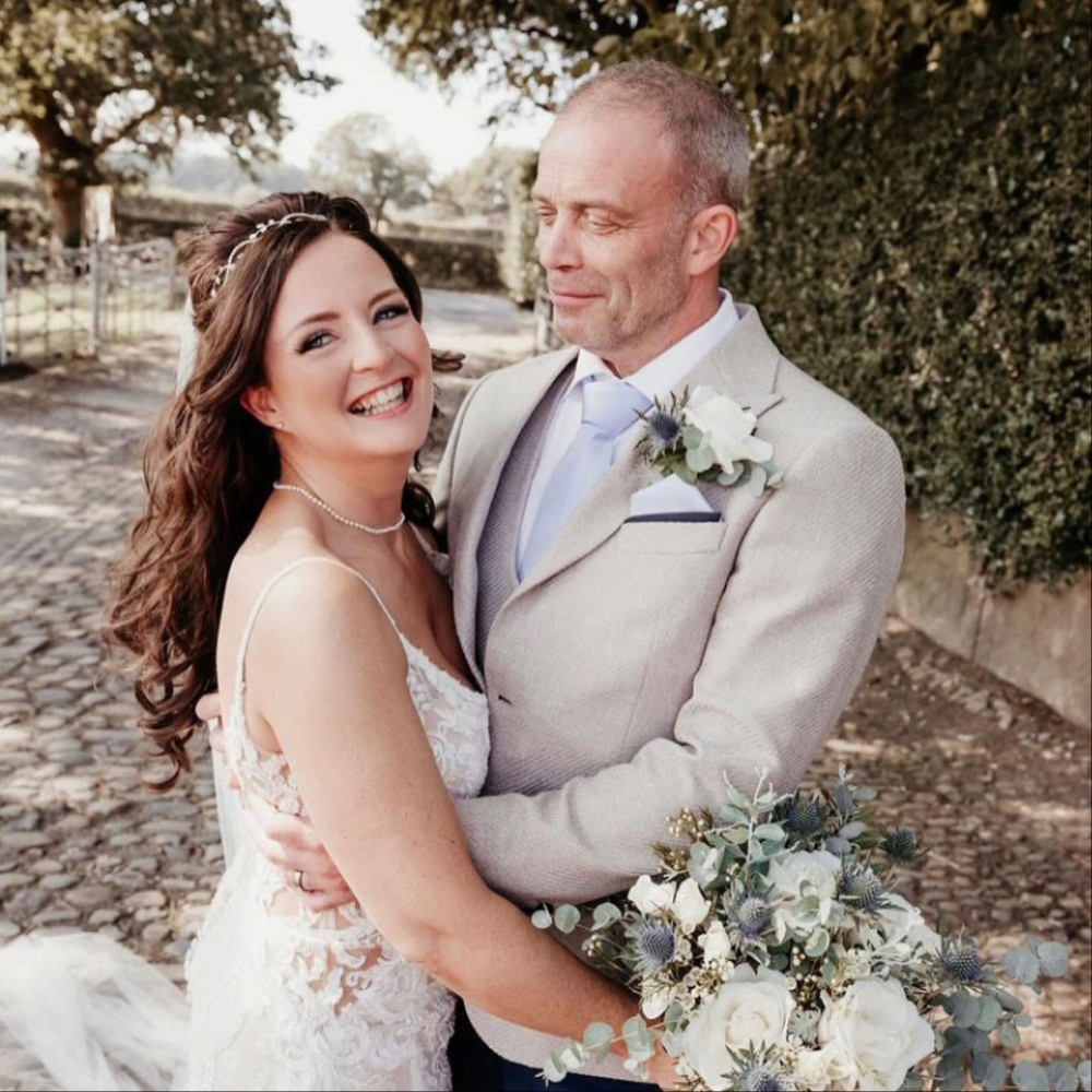 Bride and groom with their wedding flowers