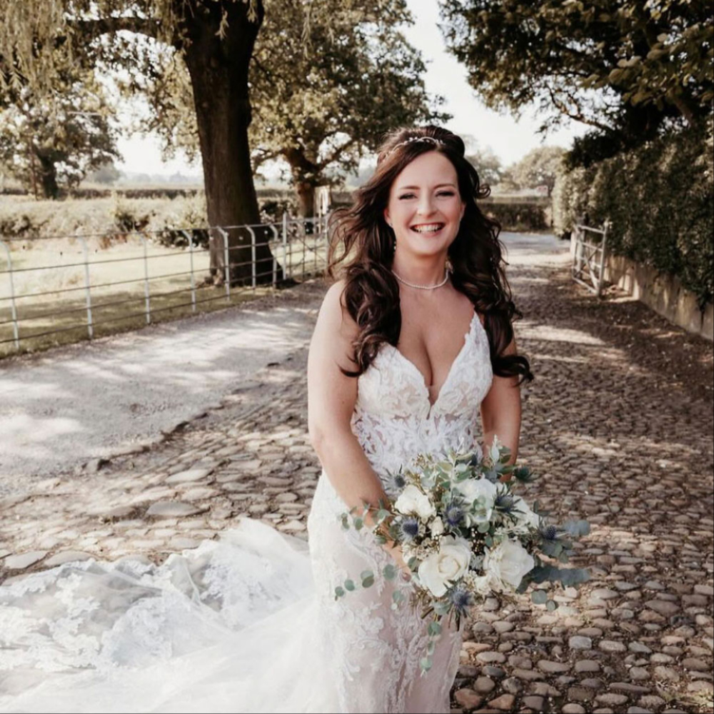 Bride with wedding flowers at the ceremony venue