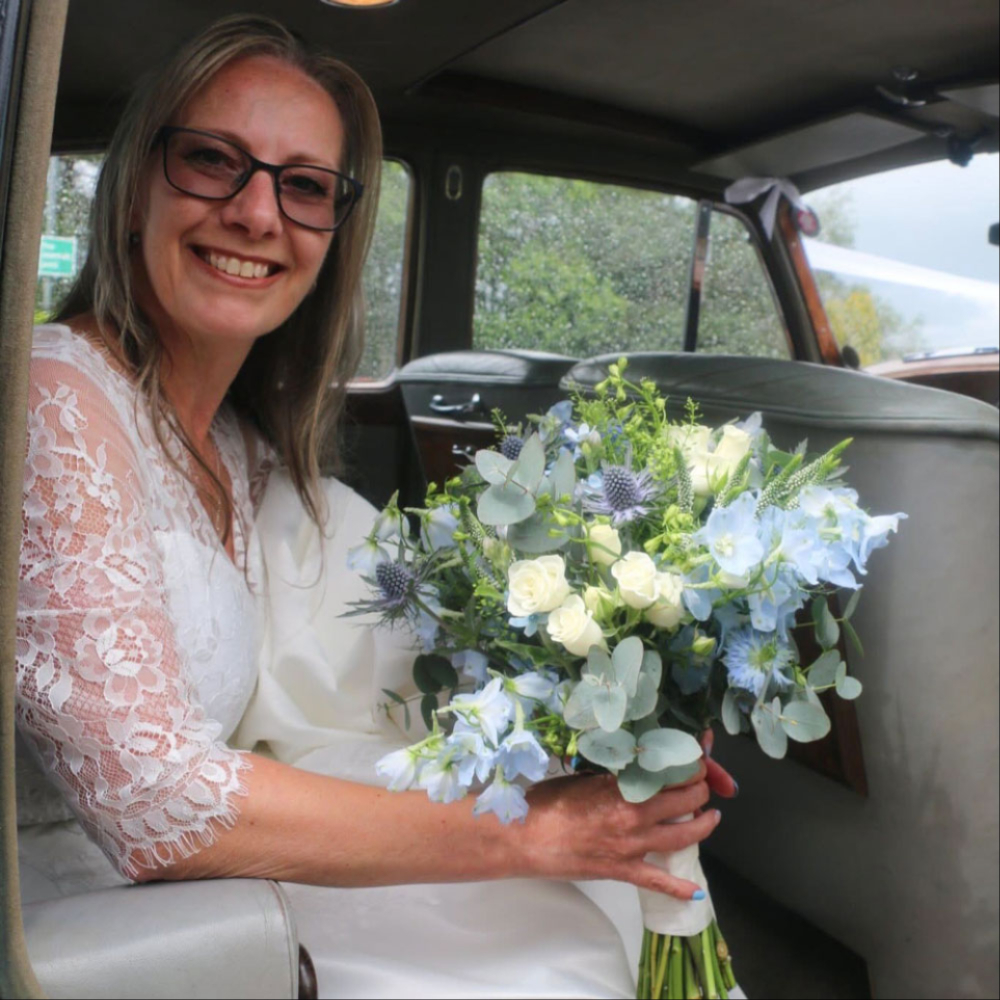 Bridal bouquet held in the wedding car