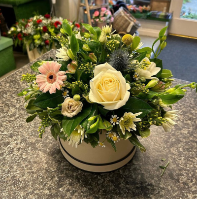 Elegant Hatbox - A timeless hat box arrangement designed in soft ivory, blush and fresh green tones for an effortlessly elegant look. Beautifully presented in a stylish keepsake hat box, this compact design offers a graceful balance of texture and colour, making it a thoughtful gift for birthdays, anniversaries, sympathy, new baby celebrations or simply to brighten someone's day. Handcrafted by our expert florists using the freshest seasonal blooms and foliage available, each arrangement is unique while maintaining its refined and sophisticated style.