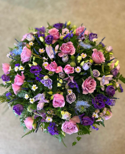 Enchanted Blush Posy - A beautifully handcrafted posy arrangement in enchanting shades of blush pink, lavender, and soft violet, designed to celebrate a life with elegance and grace. Featuring a delicate blend of seasonal blooms, textured foliage, and natural accents, this compact tribute creates a full, garden-inspired display that offers comfort and remembrance. Ideal for funeral services, memorials, or celebration of life ceremonies, each posy is individually arranged by our skilled florists using the freshest seasonal flowers, ensuring every tribute is unique and created with care.