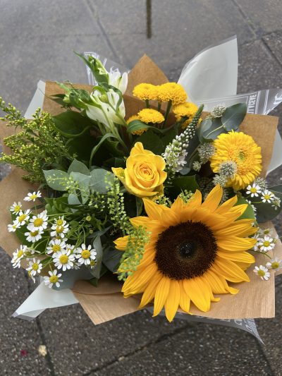 Sunny Sunflowers - Bright,Joyful and bursting with warmth.This radiant bouquet centres around magnificent sunflowers paired with a sunny mix of yellow blooms.It is the perfect choice to celebrate special moments,Lift someone’s spirits or bring some sunshine indoors.